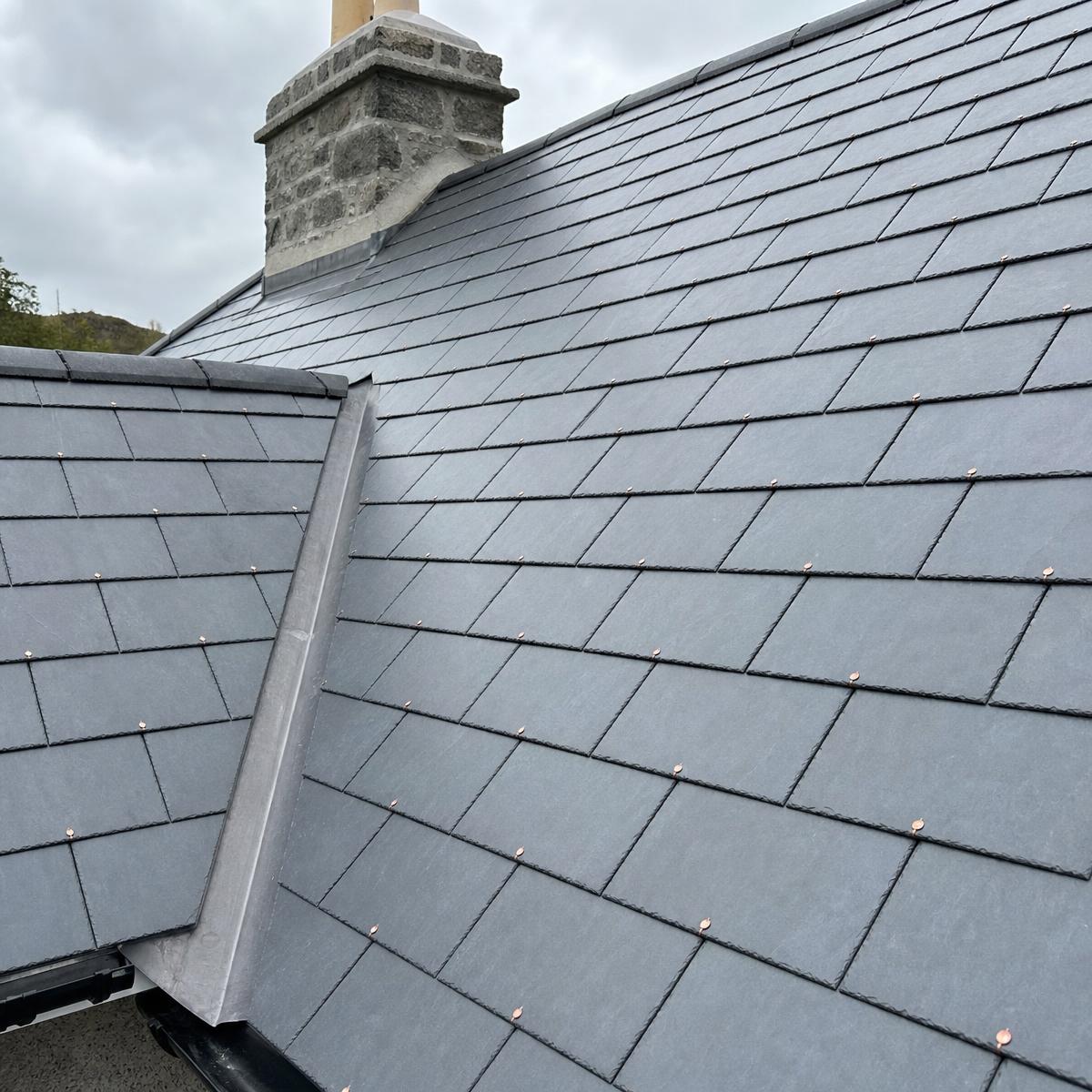 Freshly laid natural slate roof with lead flashing